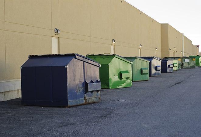 several large trash cans setup for proper construction site cleanup in Dupont